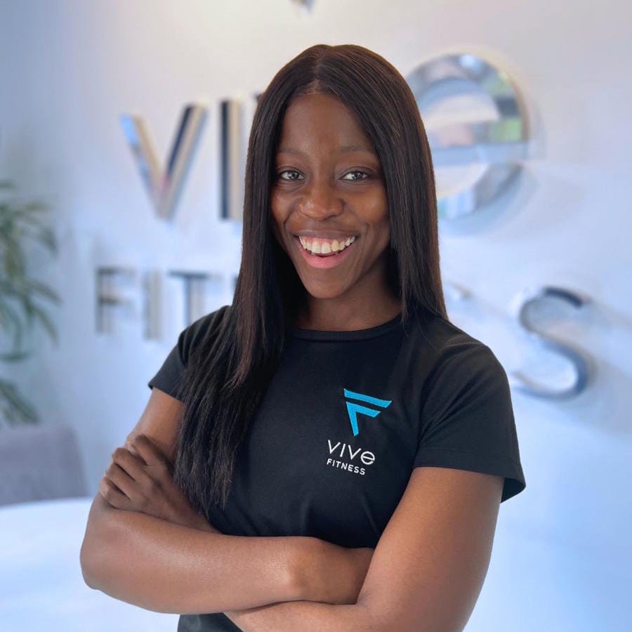 Bee Sekhu - EMS Trainer for Vive Fitness standing in studio