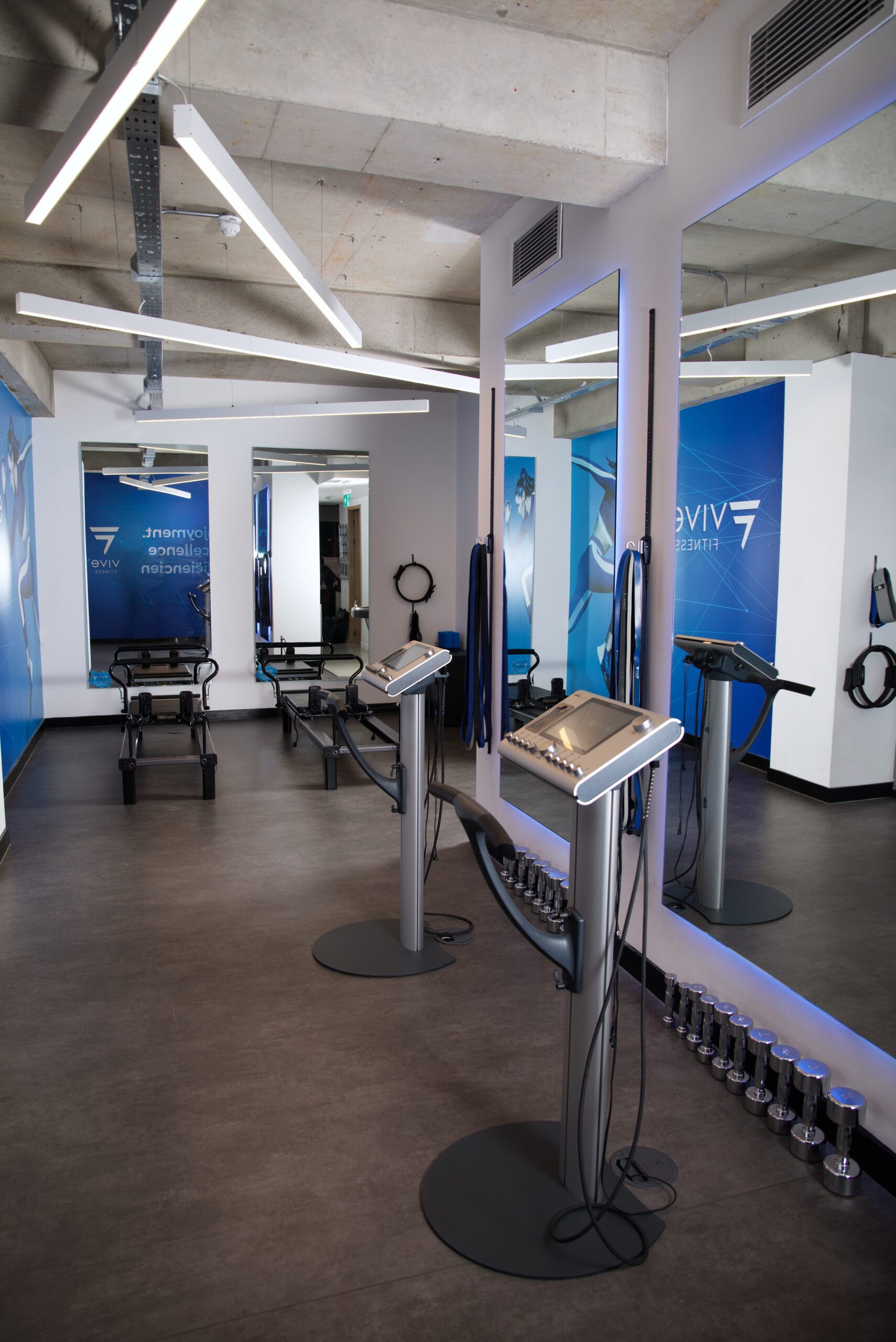 People in EMS suits doing a guided workout in a Mayfair personal training studio at Vive Fitness in London