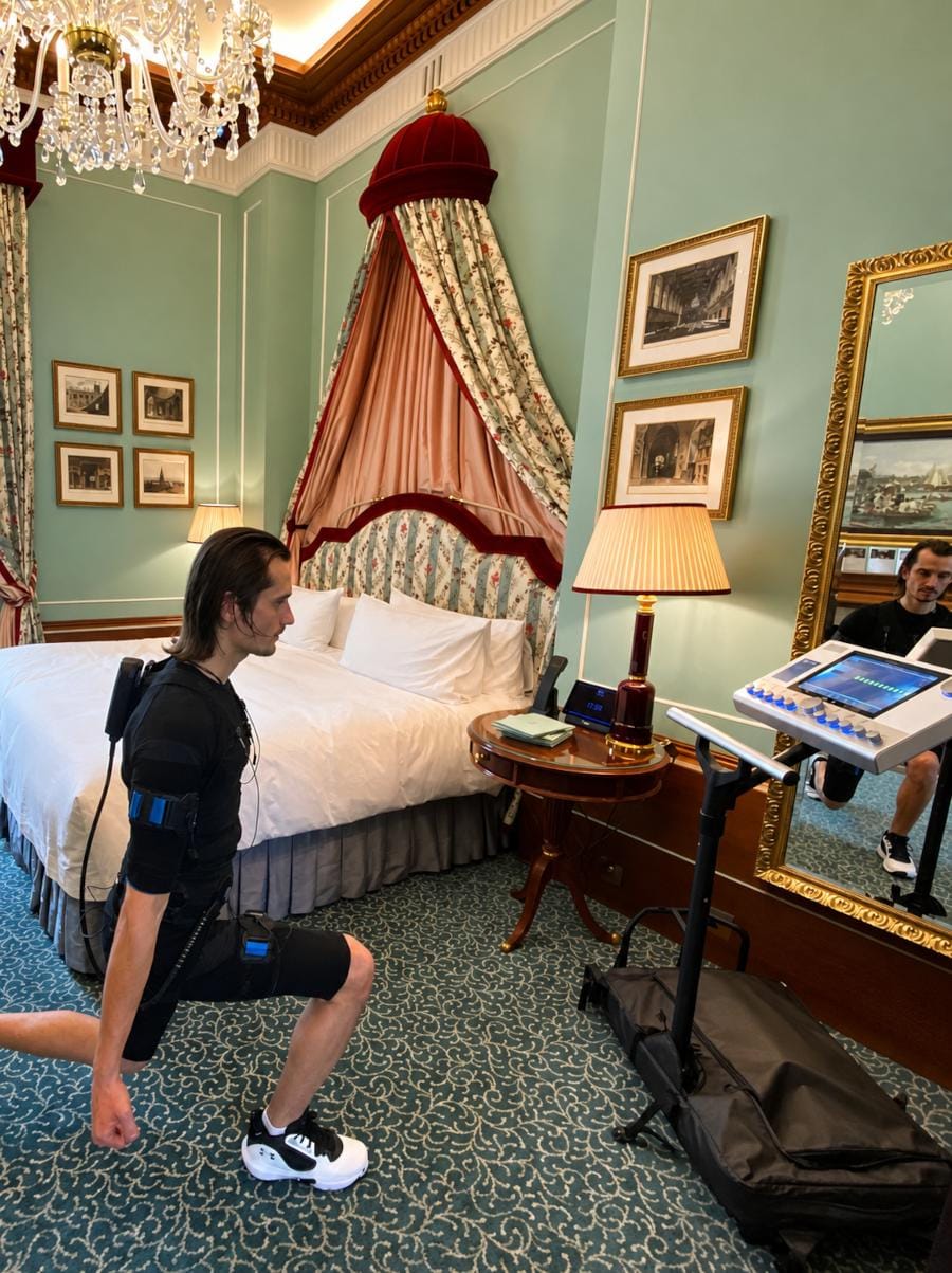Man using EMS technology to exercise in his hotel room