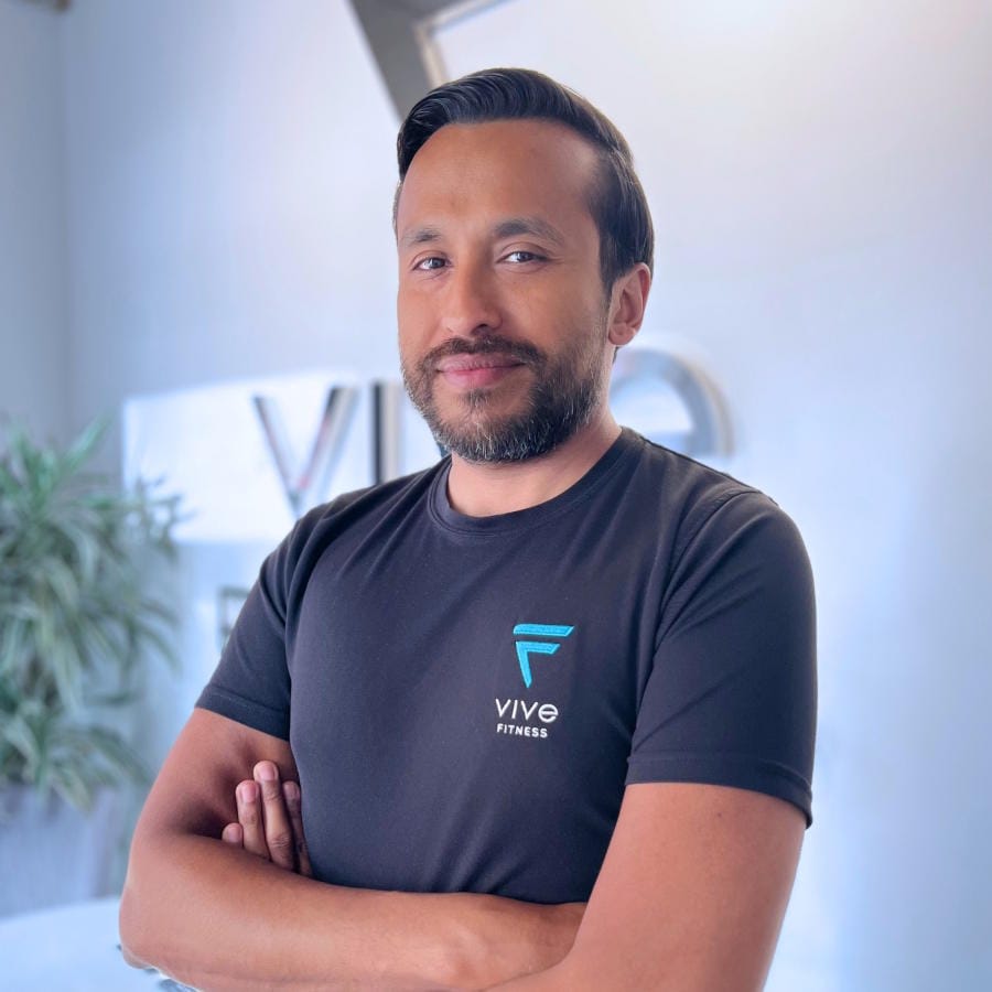 Mauricio Vega - Sports Masseur, Stretch Therapist & EMS Trainer for Vive Fitness standing in the studio