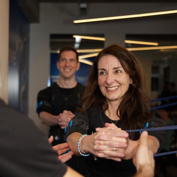 Woman using resistance band while doing EMS Training in London